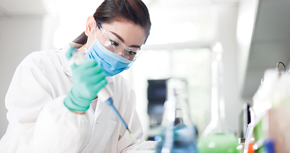 A woman working in a laboratory environment.
