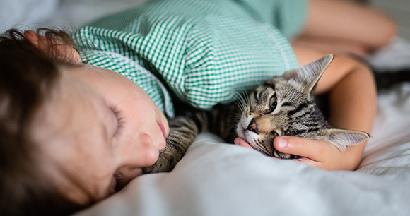 child snuggling with cat - photo by Steve