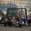 Animal welfare advocates pose in front of a billboard about ejiao