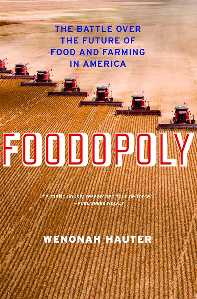 rows of crop harvesters drive through a field