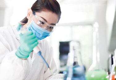 scientist works with syringe in lab