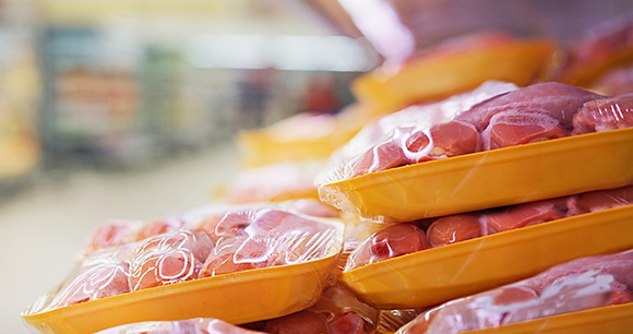 Raw chicken legs on a supermarket shelf