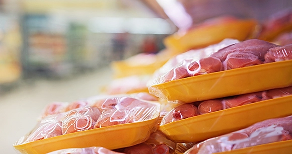 stack of chicken meat in packaged containers