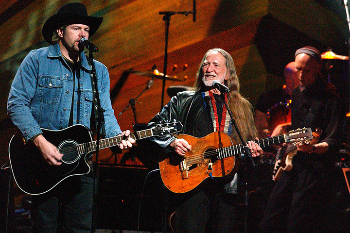 Willie Nelson performs on stage.