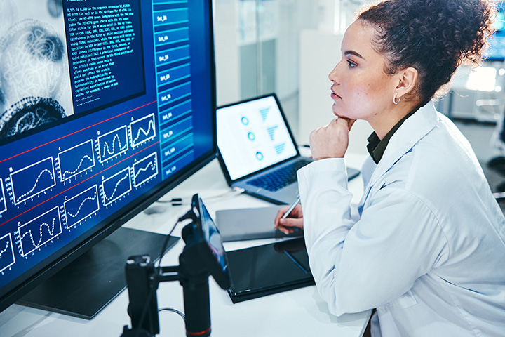 a scientist studies a computer screen