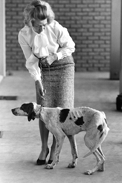 Dorothy Dyce stands with an emaciated dog that she purchased from a dealer.